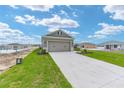 Exterior view of a home with a two-car garage and concrete driveway at 7337 Sw 89Th Ter, Ocala, FL 34481