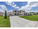 Charming two-story home displays a large driveway, a well-kept lawn, and a convenient three-car garage at 7624 Sw 60Th St, Ocala, FL 34474