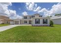 Beautiful two-story home showcases a manicured lawn, ample parking, and a functional three-car garage at 7624 Sw 60Th St, Ocala, FL 34474