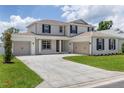 Inviting two-story home boasts a manicured lawn, three-car garage, and classic architectural elements for curb appeal at 7624 Sw 60Th St, Ocala, FL 34474