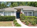 Inviting home exterior with a neatly landscaped front yard, arched windows, and a pathway leading to the front door at 8053 Sw 62Nd Ave, Ocala, FL 34476