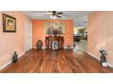 Open-concept dining room with hardwood floors leading into the kitchen at 9661 Sw 95Th Ct # B, Ocala, FL 34481