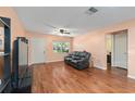 Comfortable living room area with a cozy leather loveseat and hardwood flooring at 9661 Sw 95Th Ct # B, Ocala, FL 34481