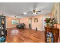 Spacious living room featuring hardwood floors, ceiling fans, and lots of natural light at 9661 Sw 95Th Ct # B, Ocala, FL 34481