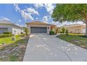 Beautiful home with a long driveway, lush lawn, and attached two-car garage at 9663 Sw 92Nd Place Rd, Ocala, FL 34481