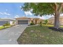 Single-story home with a well-manicured lawn, inviting curb appeal, and attached two-car garage at 9663 Sw 92Nd Place Rd, Ocala, FL 34481