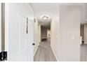 Hallway with wood-look flooring and neutral paint, leading to other rooms at 9729 Sw 97Th St, Ocala, FL 34481