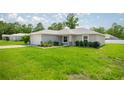 Charming single-story home with a well-manicured lawn, a two car garage and lovely landscaping at 16062 Se 89Th Ter, Summerfield, FL 34491