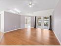 Open living room featuring hardwood floors, ceiling fan, recessed lighting and sliding doors to lanai at 17233 Se 115Th Terrace Rd, Summerfield, FL 34491