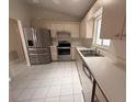 Bright kitchen with stainless steel appliances and white countertops at 17522 Se 96Th Ct, Summerfield, FL 34491