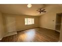 View of an open living room with wood floors and natural light from a window at 17522 Se 96Th Ct, Summerfield, FL 34491