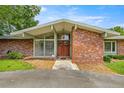 Welcoming brick home featuring a unique roof line and double door front entry at 1852 Ne 39Th Ct, Ocala, FL 34470