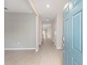 Open foyer with wood-look tile flooring leading into a bright, spacious interior, with a view down a long hallway at 1875 Nw 44 Ct, Ocala, FL 34482