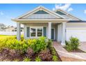 Welcoming home exterior featuring a brick pathway, lovely landscaping, and an inviting front porch with white columns at 1875 Nw 44 Ct, Ocala, FL 34482