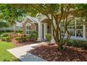 Charming home entrance featuring a stone facade and manicured landscaping at 2010 Se 25Th St, Ocala, FL 34471
