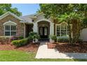 Inviting front entrance with stone accents and decorative landscaping at 2010 Se 25Th St, Ocala, FL 34471