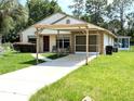 Lovely home featuring a covered carport, bright exterior, and a well-kept lawn at 21298 Sw Peach Blossom St, Dunnellon, FL 34431