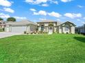 Beautiful home features a manicured lawn, decorative flower beds, and a two-car garage at 2478 Nw 53Rd Avenue Rd, Ocala, FL 34482