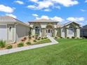Charming one-story home showcasing beautifully landscaped flower beds, arched windows and inviting walkway at 2478 Nw 53Rd Avenue Rd, Ocala, FL 34482