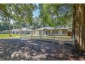 Charming single-story home featuring a well-manicured lawn and an inviting blue front door at 3065 Se 142Nd Ln, Summerfield, FL 34491