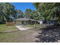 Charming single-story home featuring a well-manicured lawn and an attached garage at 3065 Se 142Nd Ln, Summerfield, FL 34491