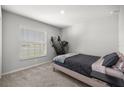 Cozy bedroom with neutral carpet, a window for natural light, and a minimalist aesthetic at 4909 Se 89Th St, Ocala, FL 34480