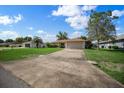 This single story home features an extra long driveway, manicured lawn and an attached two car garage at 4992 Nw 31St St, Ocala, FL 34482