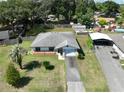 Aerial view showcasing the property's layout with a well-maintained lawn, driveway, and surrounding greenery at 5060 Ne 4Th St, Ocala, FL 34470