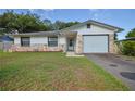 Charming single-story home with stone accents, an attached garage, and a well-maintained front yard at 5060 Ne 4Th St, Ocala, FL 34470