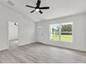Open-concept living room with light gray flooring, a ceiling fan, and natural light at 5345 Nw 4Th St, Ocala, FL 34482
