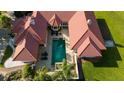 Aerial view of the home with a backyard swimming pool and outdoor living spaces at 6381 Sw 21St Court Rd, Ocala, FL 34471