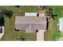 Aerial view of the single Gathering home with a brown shingle roof, a driveway and mature landscaping at 6472 Sw 106Th Pl, Ocala, FL 34476