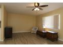 Bright and spacious living room features new floors, large window, chair and ceiling fan at 6472 Sw 106Th Pl, Ocala, FL 34476