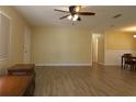 View of the open living room, with neutral colored walls, updated floors, and a ceiling fan at 6472 Sw 106Th Pl, Ocala, FL 34476