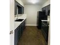 A well-equipped kitchen features dark cabinets, modern appliances, and plenty of counter space at 6820 Se 108Th St, Belleview, FL 34420