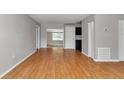 Bright living room featuring beautiful wood floors and a view into other rooms at 6820 Se 108Th St, Belleview, FL 34420