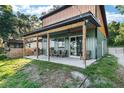 Home's backyard showing the extended patio with ample seating and the property's exterior at 754 Se 167Th Court Rd, Silver Springs, FL 34488