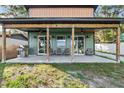 Relaxing covered patio featuring ceiling fans, outdoor lighting and patio furniture at 754 Se 167Th Court Rd, Silver Springs, FL 34488