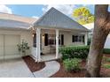 Charming front porch of a white home with black shutters and seating area at 8681 Sw 93Rd Pl # B, Ocala, FL 34481