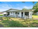Charming home with a covered porch, tasteful decorations, and landscaping offering a welcoming curb appeal at 8973 Sw 103Rd Ln, Ocala, FL 34481