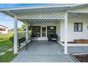 Inviting front porch with comfortable seating, lattice accents, and ample space for relaxing and entertaining guests at 8973 Sw 103Rd Ln, Ocala, FL 34481