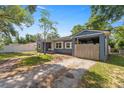 Charming single-story home with blue siding and carport, set against a clear sky at 1014 Ne 12Th St, Ocala, FL 34470