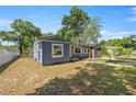 View of a single-story home featuring blue siding and a fenced yard, providing privacy at 1014 Ne 12Th St, Ocala, FL 34470