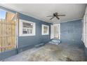 Covered back patio with ceiling fan, offering a space for outdoor relaxation at 1014 Ne 12Th St, Ocala, FL 34470