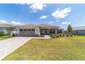 Charming one-story home featuring a brick driveway, a two-car garage, and well-manicured landscaping at 10451 Sw 98Th Place Rd, Ocala, FL 34481