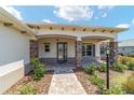 Inviting front porch with stone pillars and a charming walkway leading to the entrance at 10451 Sw 98Th Place Rd, Ocala, FL 34481