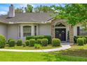 Home's exterior shows well-manicured shrubs, stone accents, and a double door entrance at 1107 Se 49Th Ave, Ocala, FL 34471