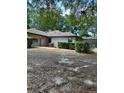 Backyard featuring well maintained bushes, trees, and a fenced in area at 1325 Nw 73Rd Ter, Ocala, FL 34482