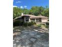 Single story home featuring architectural windows and a front yard with trees and bushes at 1325 Nw 73Rd Ter, Ocala, FL 34482
