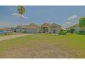Lovely single-story home with lush green lawn and beautiful landscaping at 14004 Se 94Th Ave, Summerfield, FL 34491
